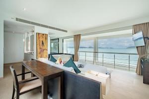 a living room with a couch and a table with a view at Raya Villa, 2 Bed Beachfront Villa Private Pool in Ban Saiyuan (1)
