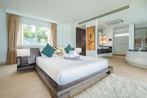 a bedroom with a large bed and a bath tub at Raya Villa, 2 Bed Beachfront Villa Private Pool in Ban Saiyuan (1) +63 photos