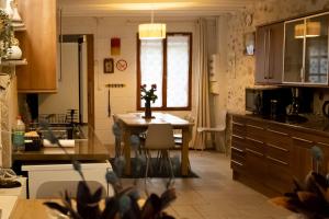 a kitchen with a table with a vase of flowers on it at GITE D'HAUTEVESNES in Hautevesnes