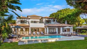 an exterior view of a house with a swimming pool at Pine Cliffs Village in Albufeira