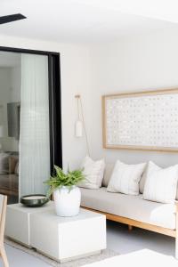 a white living room with a white couch at Stylish West Coast 3BR Retreat with Pool Near Beach in Saint James