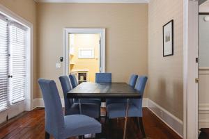 a dining room with a table and blue chairs at Sweet Caroline in Key West +19 photos