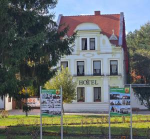 a hotel building with signs in front of it at Bike Hostel&Camp in Przewóz
