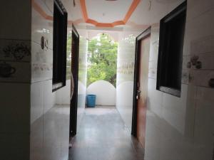 a hallway with an open door in a house at Hotel O Sai Laxmi in Shirdi