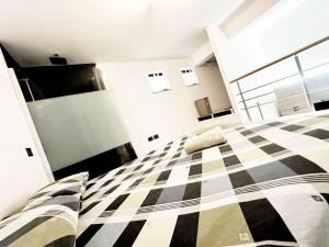 a bedroom with a black and white checkered bed at Casa Terranova in Pozzallo