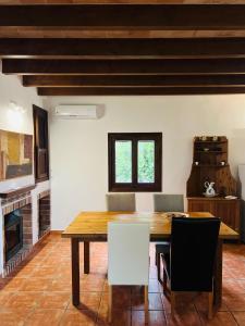 een eetkamer met een houten tafel en stoelen bij Villa Es Puig, piscina y vistas a la montaña in Santa Margalida
