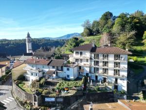 an aerial view of a hotel in a town with a clock tower at Guesthouse Giulietta e Romeo in Cossogno