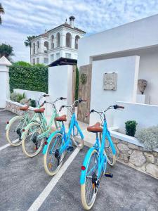 three bikes parked in a parking lot in front of a building at Casa Chica 2 in Sanlúcar de Barrameda