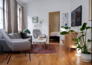 a living room with a couch and a table at Cheap Room in The Heart of Brosundet in Ålesund +3 photos
