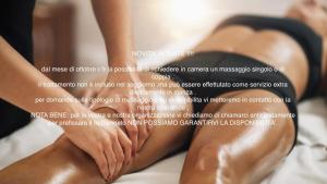 a woman lying on a bed with her feet on her legs at Le Perle di Bà - Suites with Jacuzzi in Polignano in Polignano a Mare