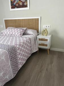 a bedroom with a bed and a night stand at La terraza de la subbética in Luque