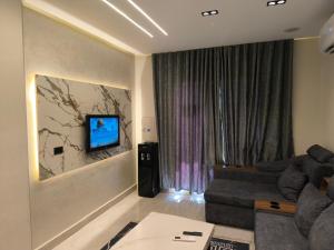 a living room with a couch and a flat screen tv at شاليه 3 غرف للعائلات فقط Lasirena Mini Egypt Resort Ain Sokhna Families only in Ain Sokhna