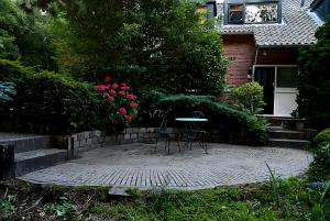 two chairs and a table in front of a house at Villa in the forest of Amsterdam with Pool in Velsen-Zuid
