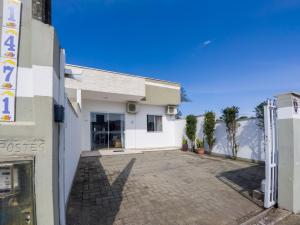 een wit gebouw met een oprit ervoor bij Curta Praia de Armação - Casa Violeta in Penha