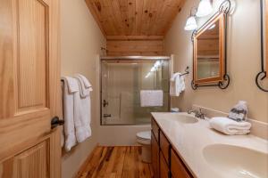 a bathroom with a sink and a shower and a toilet at Cozy Cabin in Vilas +33 photos