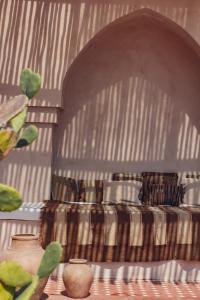 a bedroom with a bed with a striped blanket at Villa Pinkaboo - Gorgeous and Luxury One-Bedroom Villa in the Heart of Canggu in Canggu