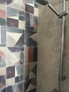 a shower in a bathroom with colorful tiles at La terraza de la subbética in Luque +44 photos
