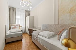 a bedroom with two beds and a desk in it at Meidling Rooms I 1 Min to U6 I Self Check In in Vienna +73 photos