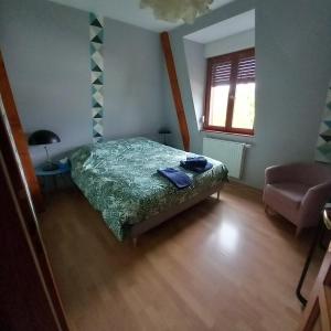 a small bedroom with a bed and a window at Les pervenches in Illkirch-Graffenstaden