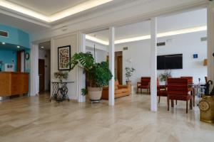 a living room with a table and chairs at Hotel Miramar Badalona in Badalona