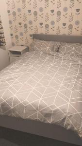 a bed with a white comforter in a bedroom at The welcoming home in Saint Michaels