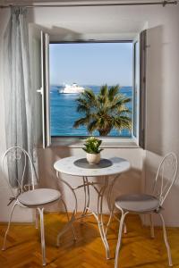 a table and two chairs in front of a window at Apartment Banjo Polo in Split
