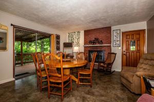 a dining room with a table and chairs and a fireplace at Three Bedroom Cabin in Nashville