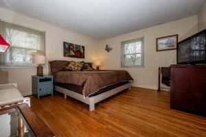 a bedroom with a bed and a flat screen tv at Three Bedroom Cabin in Nashville