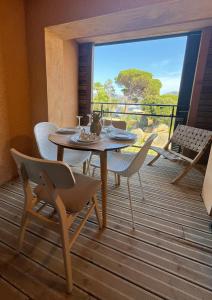 une salle à manger avec une table et des chaises sur une terrasse dans l'établissement amazing sea front apartment, à Pianottoli-Caldarello