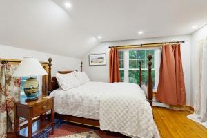 a bedroom with a bed and a window at Harbor House in Boothbay Harbor