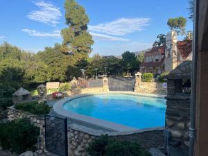 a large swimming pool in a yard next to a house at Magic Castle Unit 7 in Santa Clarita