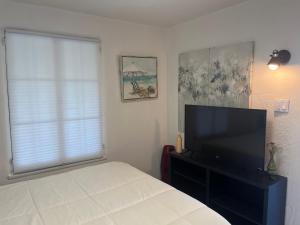 a bedroom with a bed and a flat screen tv at Magic Castle Unit 7 in Santa Clarita