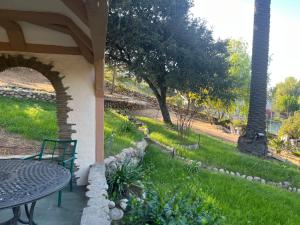 a patio with a table and a lawn with a tree at Magic Castle Unit 7 in Santa Clarita
