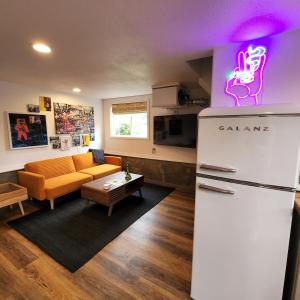 a kitchen with a refrigerator and a living room at Unique Farm Apartment with Woodstove in Eureka