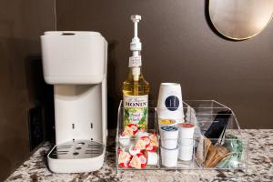 a bottle of wine sitting on a counter next to a mixer at Hollyhock Suite 512 in Louisville