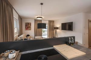 a living room with a table and a couch at monas home mayrhofen in Mayrhofen