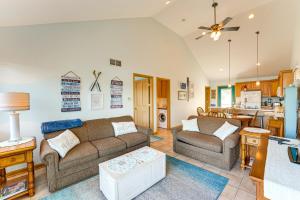 a living room with two couches and a kitchen at 13 Mi to South Haven Lakefront Retreat with Dock! in Grand Junction +27 photos