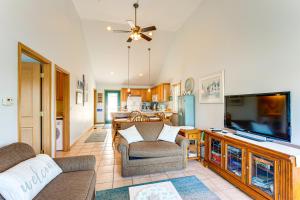 a living room with a flat screen tv and a couch at 13 Mi to South Haven Lakefront Retreat with Dock! in Grand Junction