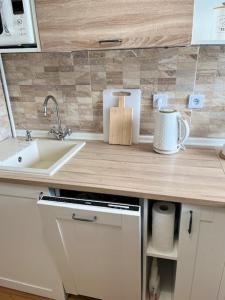 a kitchen with a sink and a counter top at Cute apartment with amazing balcony near Center in Koliba