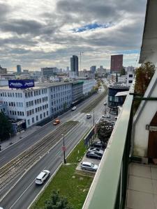 a view of a city with cars on a highway at Cute apartment with amazing balcony near Center in Koliba