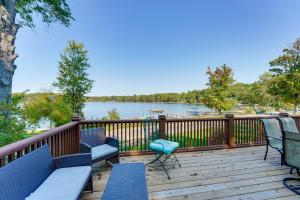 a deck with chairs and a view of a lake at 13 Mi to South Haven Lakefront Retreat with Dock! in Grand Junction