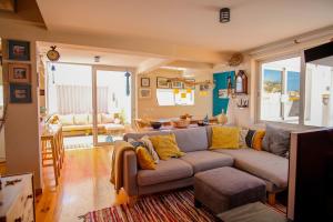 a living room with a gray couch and yellow pillows at Casa do Mar - Familiar T3 Duplex - Terraço - Central in Nazaré
