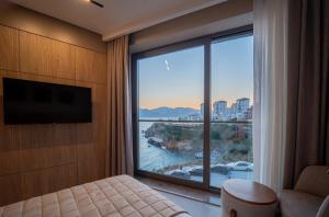 a room with a large window with a view of the water at Reev Coffee House in Antalya +19 photos