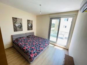 a bedroom with a bed and a large window at Rose Gardens Cozy Villa in Paphos City +13 photos