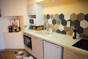 a kitchen with a sink and a counter top at La Verrière in Poitiers