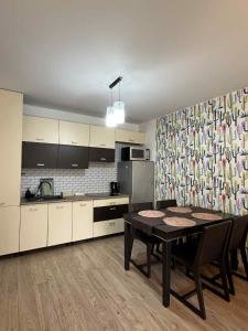una cocina con mesa con sillas y un asterisco de mesa en Apartament Enea, en Oleśnica