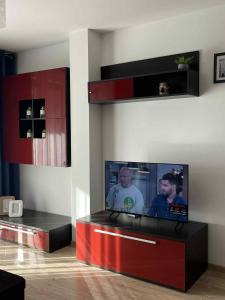 a living room with a flat screen tv on a wall at Apartament Enea z balkonem in Oleśnica