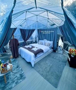 a bedroom with a bed in a tent at Naraview at phuchifa in Thoeng