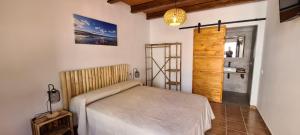 a bedroom with a bed in a room at Casa l'Arrossal - Adults Only in El Poblenou del Delta