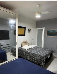 a bedroom with a bed and a large mirror at Apartamento na graça, 03 suítes, Sua melhor opção em Salvador in Salvador +26 photos